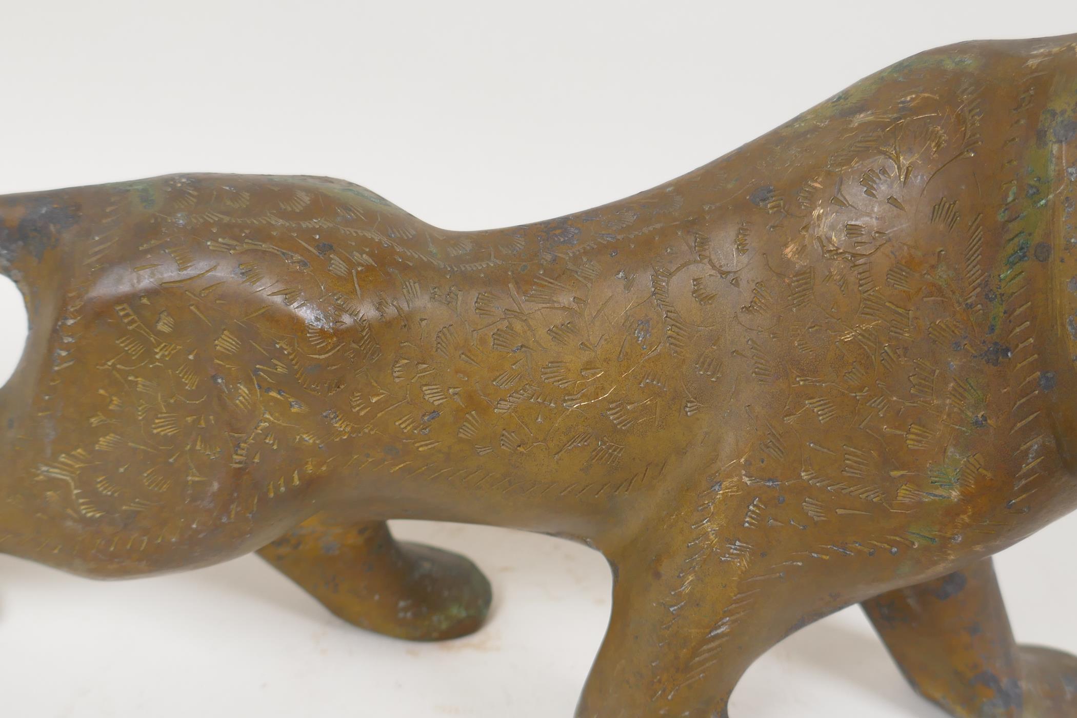 An Eastern stylised yellow metal figure of a lion, 15" long - Image 3 of 6