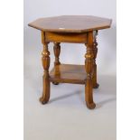 A Victorian oak two tier octagonal top centre table, raised on shaped fluted supports with splayed