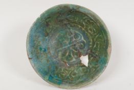 A Persian pottery bowl with impressed decoration and green glaze, AF, 3½" diameter