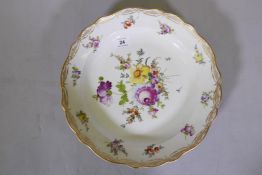 A Meissen shallow bowl with gilt borders and hand painted floral spray decoration, 12" diameter