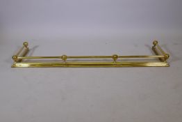 An antique brass fire fender, 51" x 14"