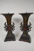A pair of Japanese bronze and marble lamp bases with embossed gilt panels