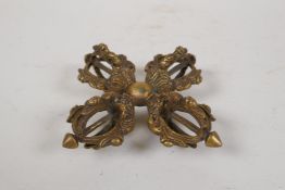 A Tibetan gilt bronze double vajra, 4" x 4"
