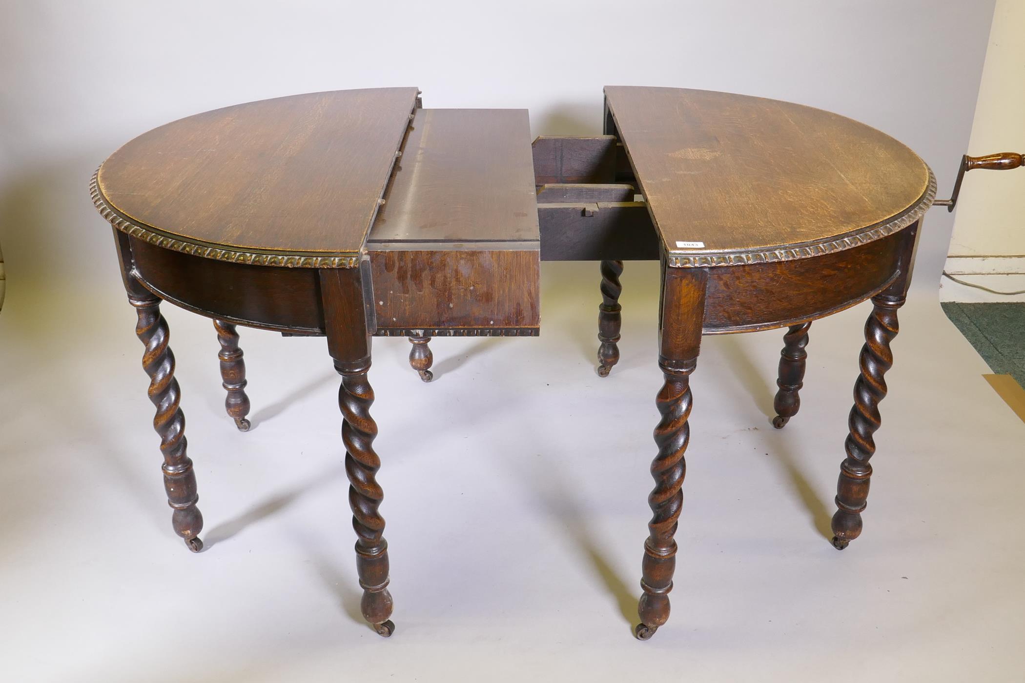 An early C20th oak wind out dining table, raised on eight handed barleytwist supports, with extra - Image 3 of 6