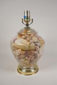 A shell filled glass table lamp with metal mounts, 13" high