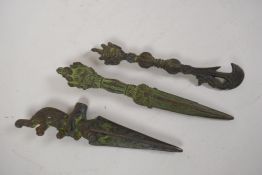 Two Tibetan cast iron ceremonial phurbas, and a similar ceremonial kartika, 8½" long