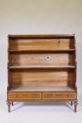 A Georgian style mahogany waterfall bookcase, with galleried top and two shelves over two drawers,