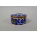 An Islamic enamelled metal box and cover with calligraphy decoration, 3" diameter