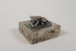 A Chinese white metal seal, the knop in the form of a water buffalo, 2½" x 2½"