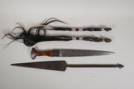An African dagger with leather handle, two African fly whips with metal banded handles, and a