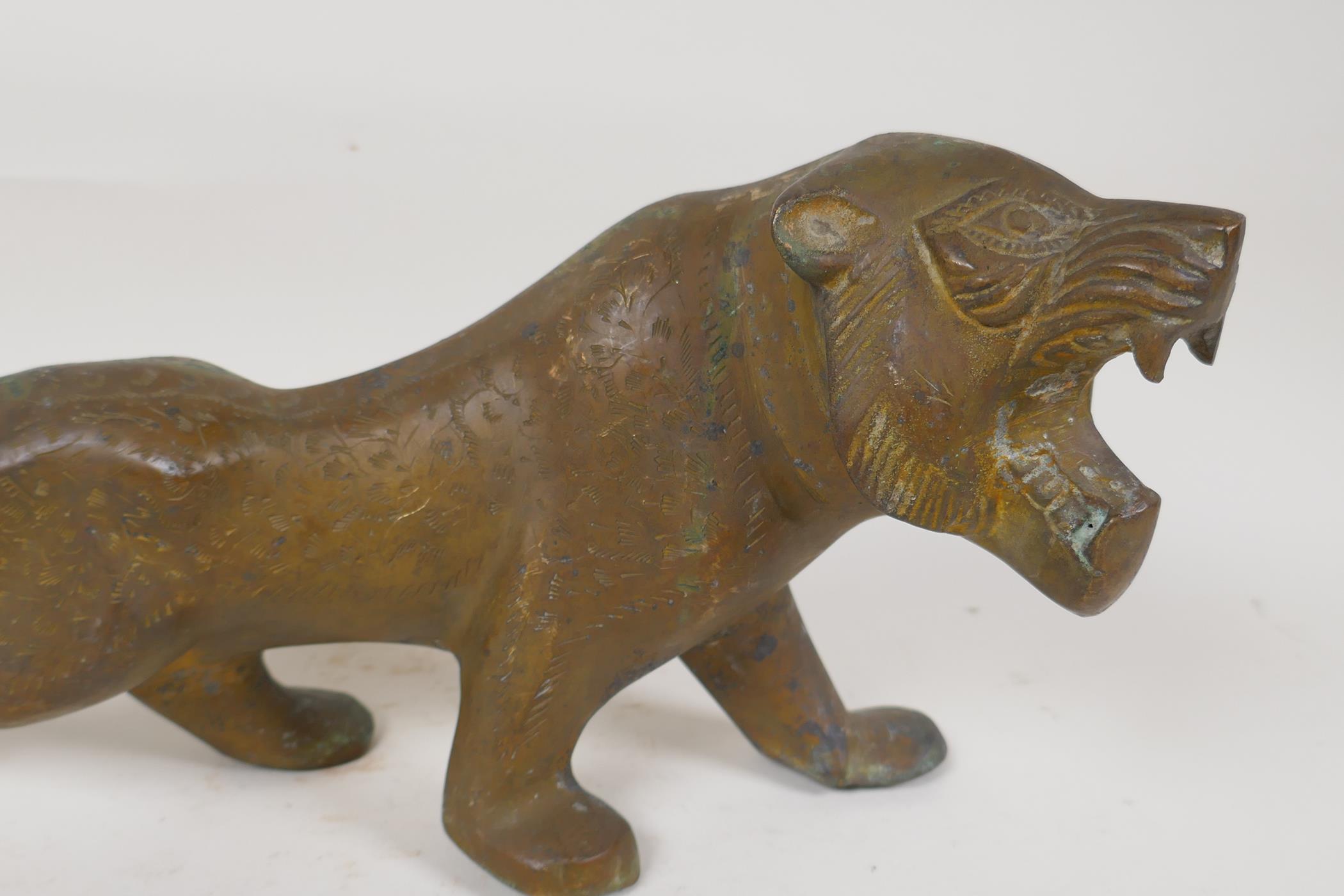 An Eastern stylised yellow metal figure of a lion, 15" long - Image 2 of 6