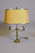 A brass two branch table lamp, with swag and tassle decoration, 21½" high