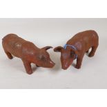 A pair of cast iron garden figures of piglets, 11" long