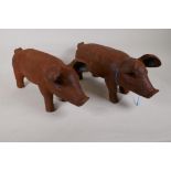 A pair of cast iron garden figures of pigs, 17" long