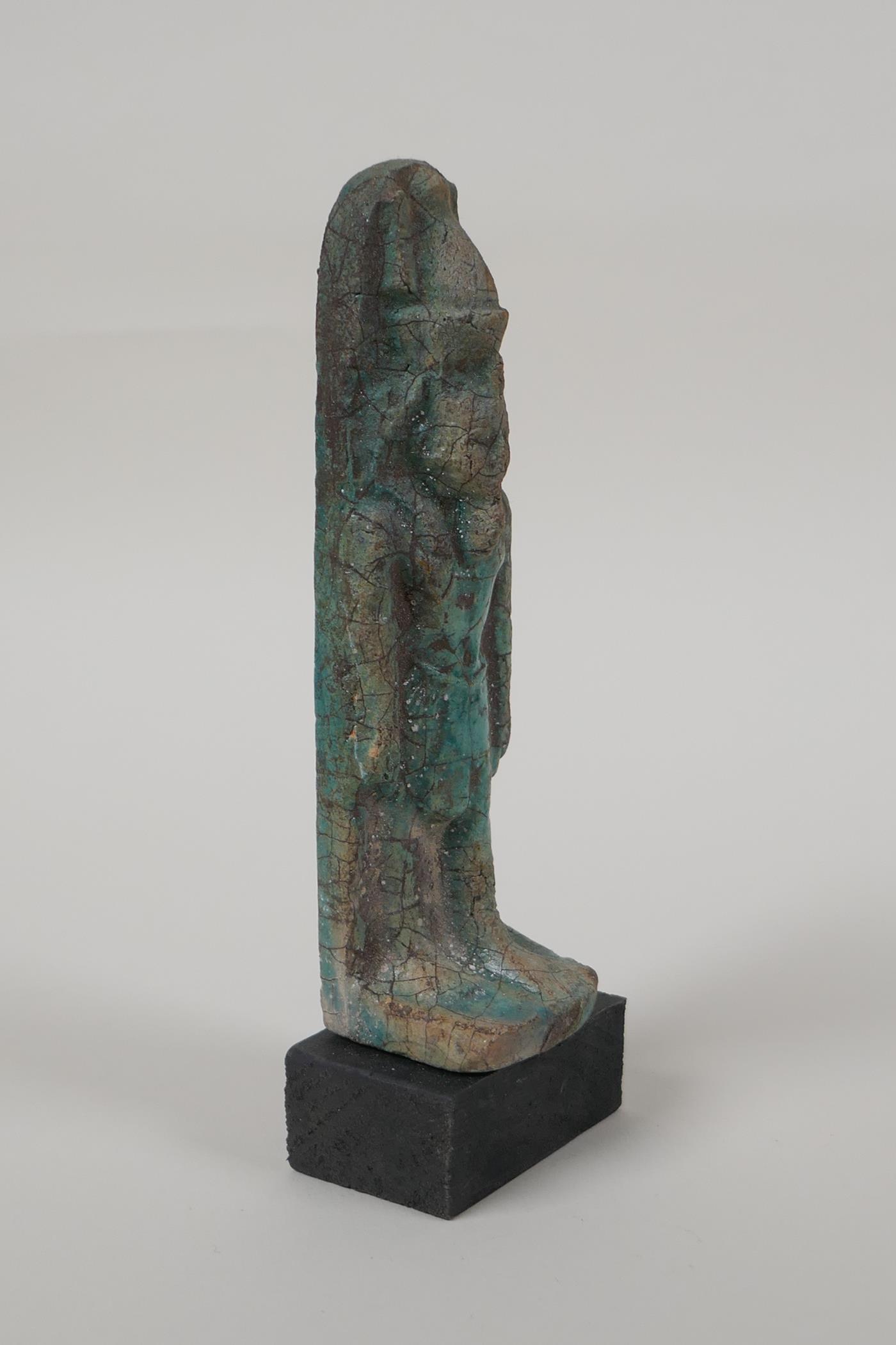 An Egyptian turquoise glazed faience shabti, mounted on a display base, 5" high - Image 2 of 4