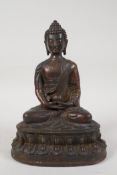 A Chinese gilt bronze figure of Buddha seated in meditation, 8½" high