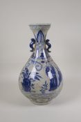 A Chinese blue and white crackleware pear shaped vase with two handles, decorated with figures in