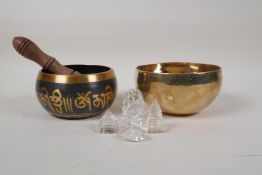 A Tibetan gilt brass singing bowl, and another similar, together with four moulded and cut glass