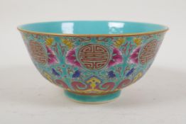 A polychrome porcelain rice bowl with enamelled lotus flower, bat and auspicious symbol