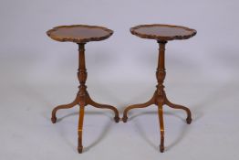 A pair of mahogany wine tables with pie crust tops on turned supports and tripod feet, AF repairs,