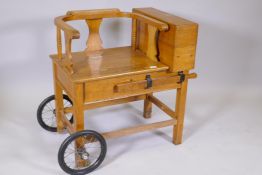 A set of oak jockey scales with cart wheels, bear label C.F Thakray Ltd, Leeds, 35" x 20" x 31"