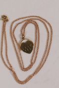 A 9ct gold spinning (I love you) pendant on a long 9ct gold chain, 4.8g