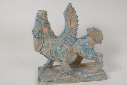 A Persian terracotta figure of a winged horse, traces of blue glaze, 9½" high