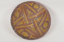A Moorish earthenware bowl painted with geometric designs, 9" diameter