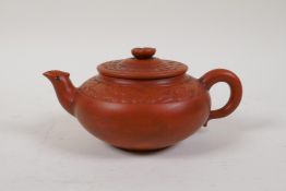A Chinese YiXing tea pot with moulded prunus blossom decoration, impressed mark to base, 4" diameter