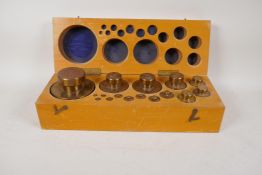 A complete boxed set of brass weights, 1g - 5kg, 16" x 5½"