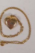 A 9ct gold heart locket on a delicate 9ct gold chain, gross 3.6g