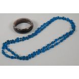 An agate bangle and a blue glass bead necklace, 32" long