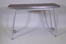 An Italian Calligaris 'Olivia' brushed steel folding table, 43½" x 32", 30" high, extended