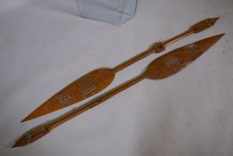 A pair of Polynesian carved wood ceremonial 'spear' paddles, 64" long