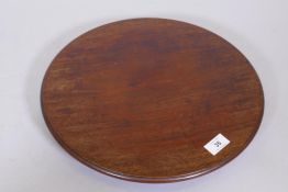 A mahogany revolving table stand, fitted with three brass and leather castors, 15" diameter