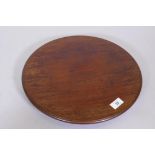 A mahogany revolving table stand, fitted with three brass and leather castors, 15" diameter