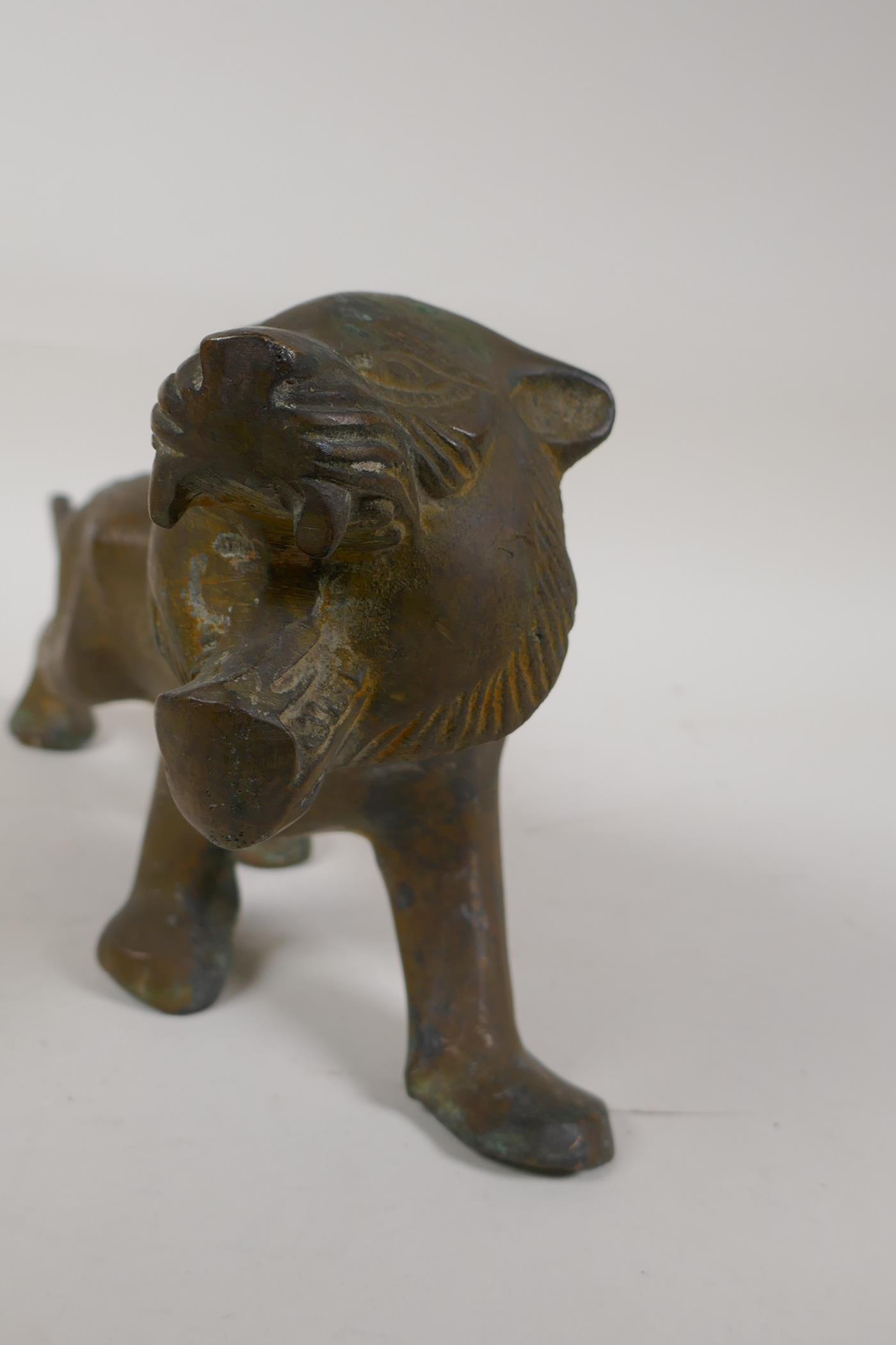 An Eastern stylised yellow metal figure of a lion, 15" long - Image 5 of 6