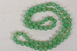 A pale green jade bead necklace, 34" long
