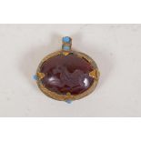 A Persian gilt metal pendant set with hardstone intaglio and turquoise beads