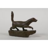 A Japanese bronze okimono of an otter, indistinct character script to side, 2½" long
