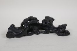 A Chinese ebonised hardwood brush rest carved in the form of a tree root, 7½" long