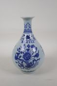 A Ming style blue and white porcelain pear shaped vase decorated with a lotus flower bouquet,