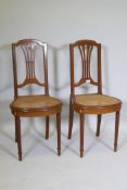 A pair of C19th continental neo-classical style mahogany and satinwood banded side chairs, with cane