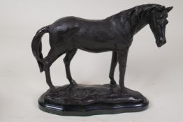A bronze figure of a horse on a black marble base, 9" high, 10" long