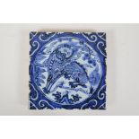 A Chinese Ming style blue and white porcelain temple tile with kylin decoration, 8" x 8"