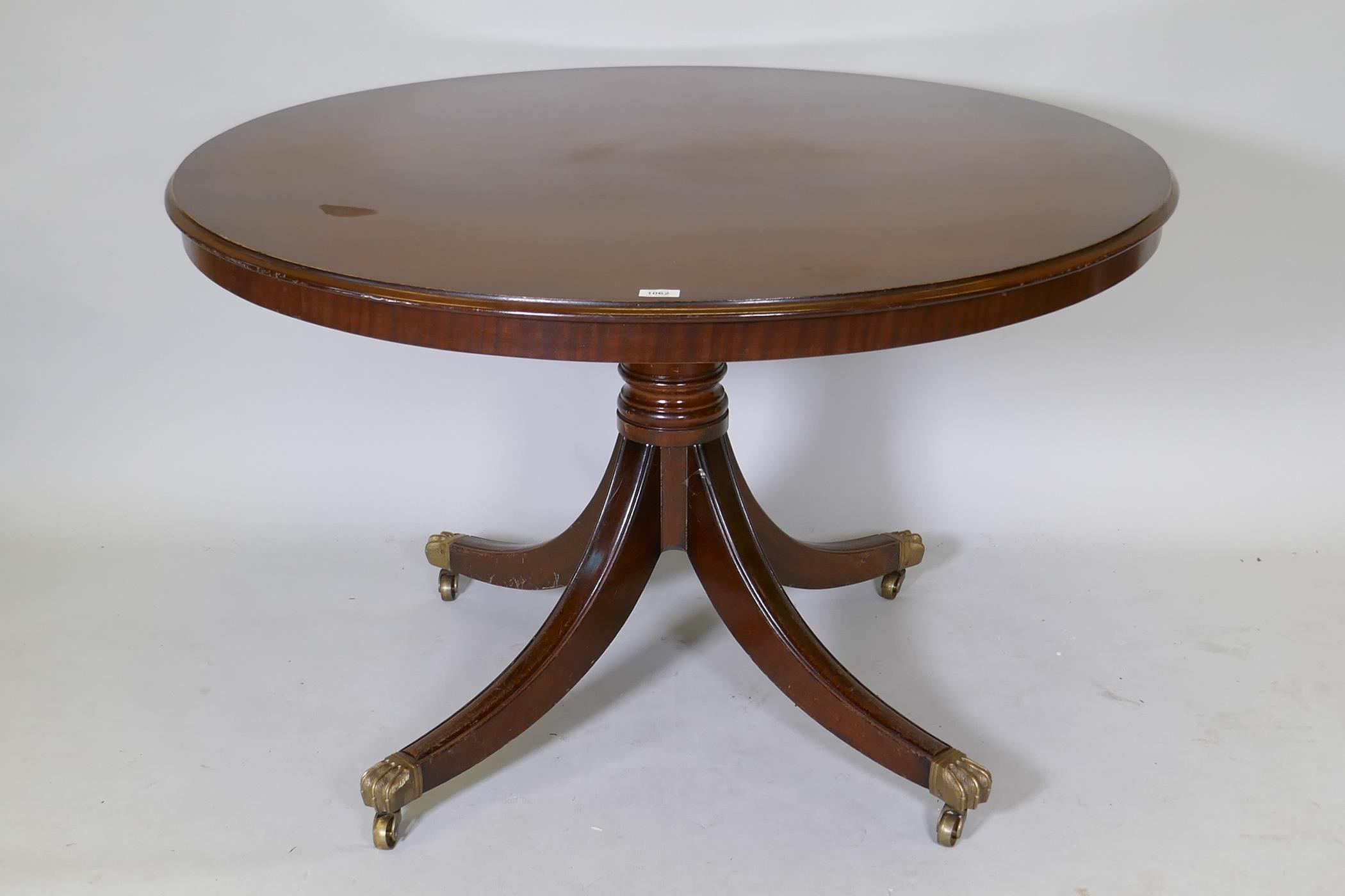 A Regency style mahogany centre/breakfast table with solid top, raised on a turned column with splay
