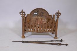 Antique cast iron fire basket with fleur de lys decoration, a poker and tongs, and cross cut saw,