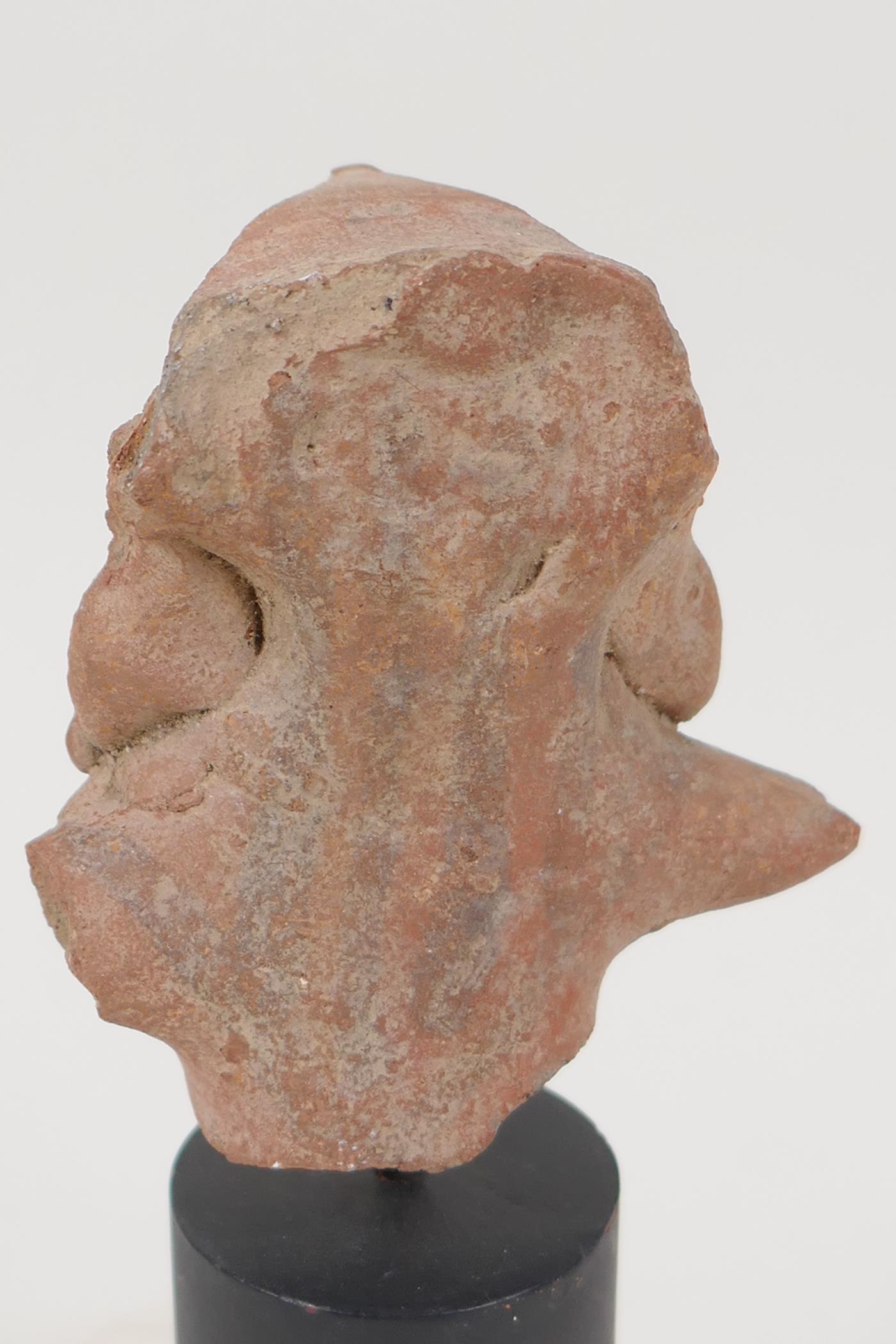 An Eastern terracotta head, 3" long, on turned stand - Image 3 of 3