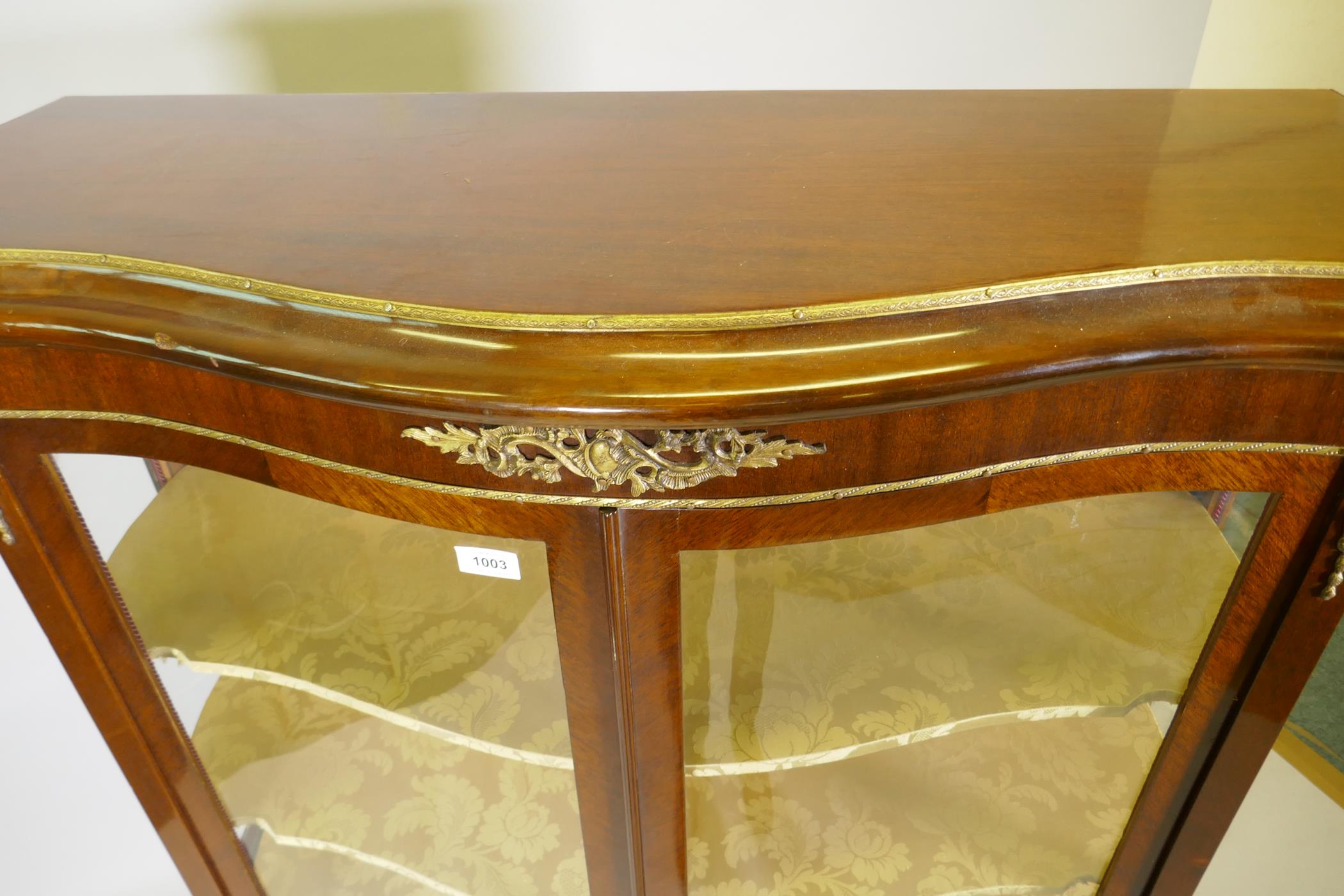 A French marquetry inlaid mahogany serpentine front vitrine with brass mounts, the interior with - Image 5 of 6