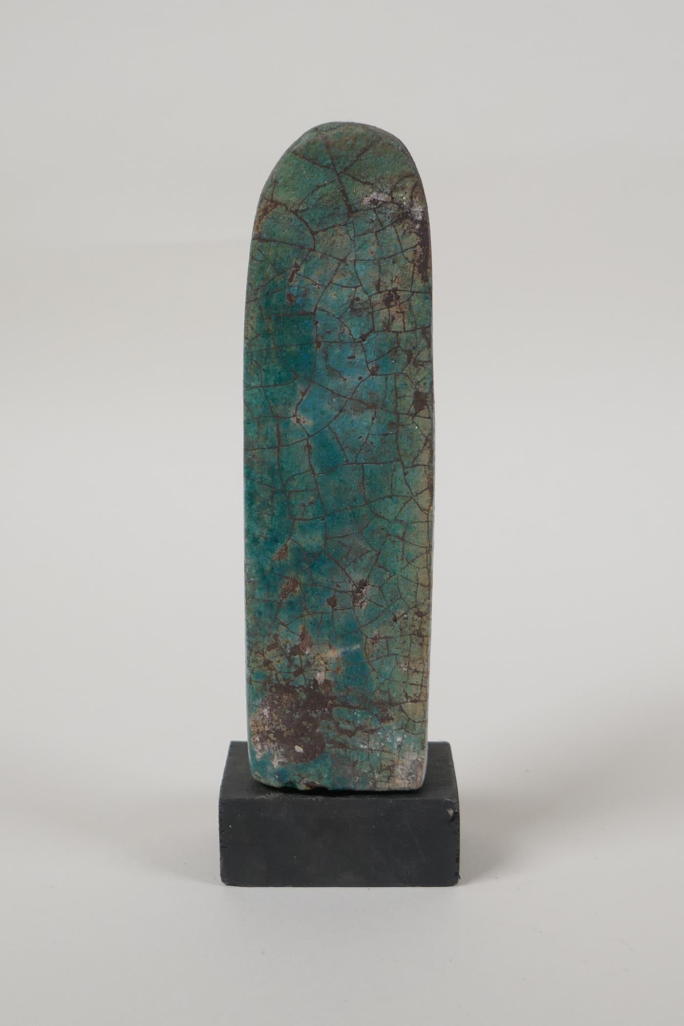 An Egyptian turquoise glazed faience shabti, mounted on a display base, 5" high - Image 3 of 4